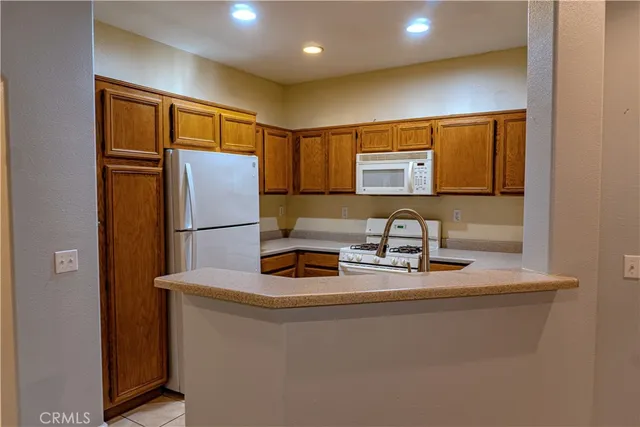 a kitchen with a refrigerator and a sink