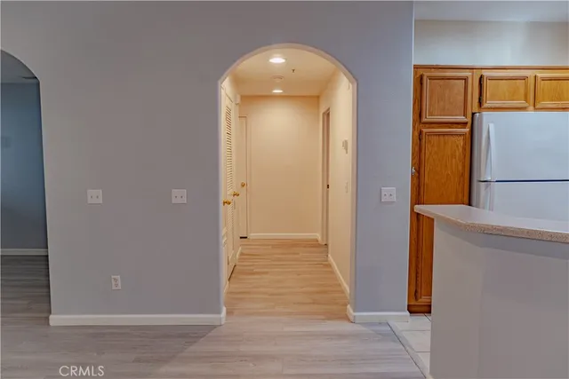 a view of a hallway with wooden floor