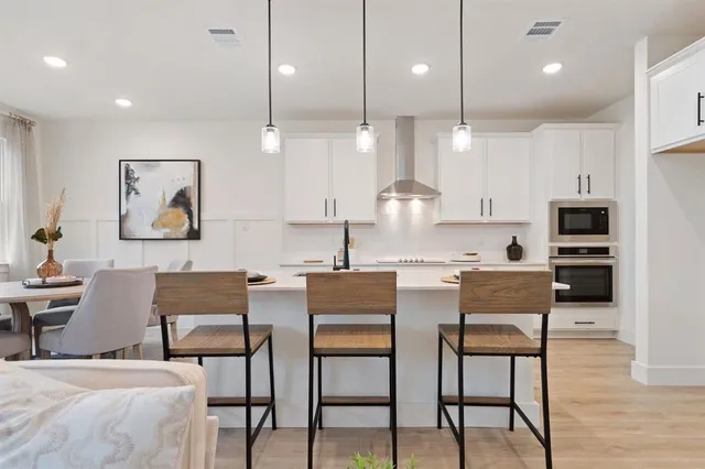 a dining room with furniture and wooden floor
