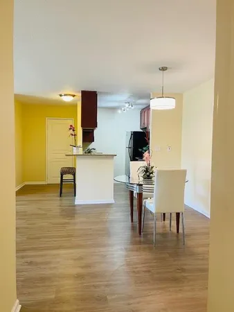 a view of a room with wooden floor and a sink