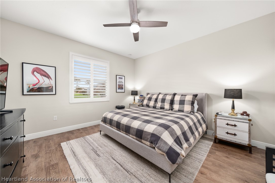 4734 Haw Branch Road, Unit 110 Sebring, FL 33875 - Photo 18 of 50 a bedroom with a large bed a chandelier and a window