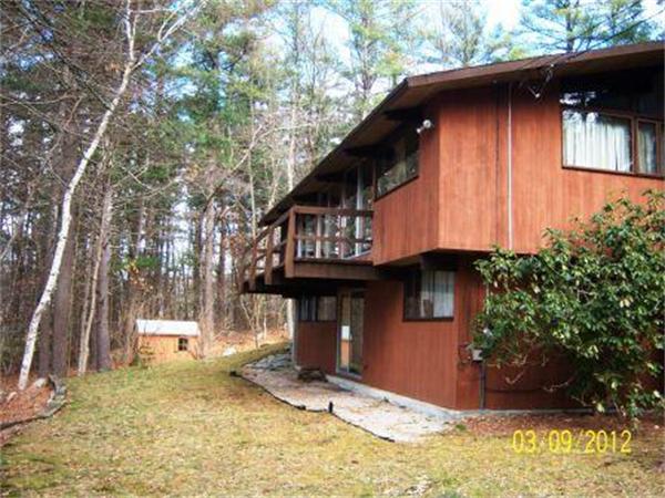 149 Judy Farm Road Carlisle, MA 01741 - Photo 4 of 10 a front view of a house with a yard