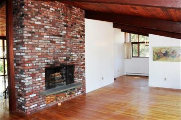 149 Judy Farm Road Carlisle, MA 01741 - Photo 9 of 10 a view of an empty room with wooden floor and a fireplace