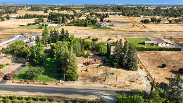 an aerial view of residential houses with yard