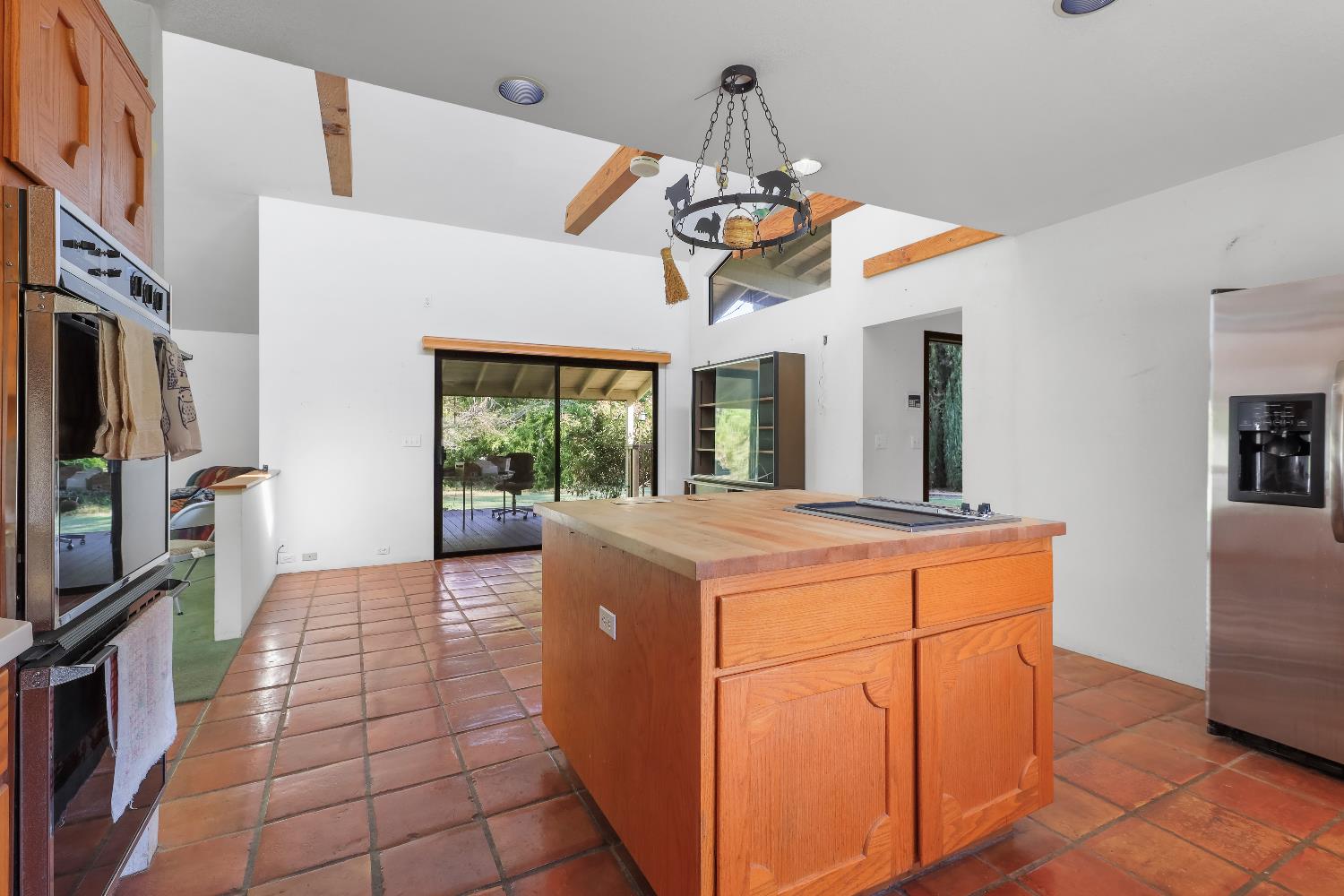 9537 Alta Mesa Road Wilton, CA 95693 - Photo 18 of 33 a view of a kitchen with a stove cabinets and a floor to ceiling window