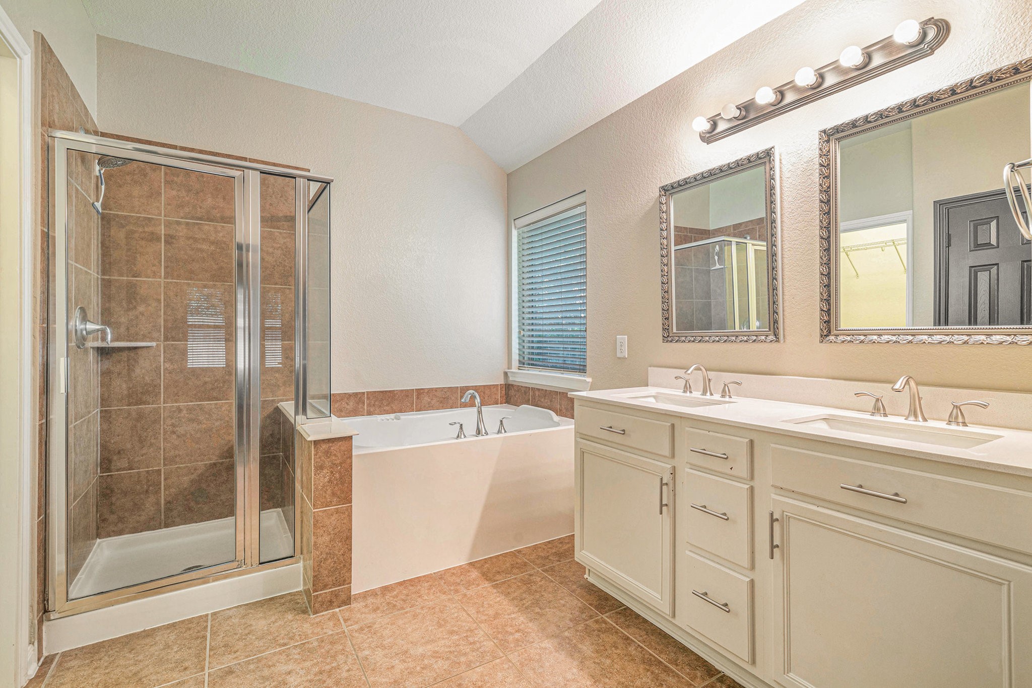 139 North Hawkhurst Circle Magnolia, TX 77354 - Photo 11 of 26 a spacious bathroom with a tub sink shower and mirror