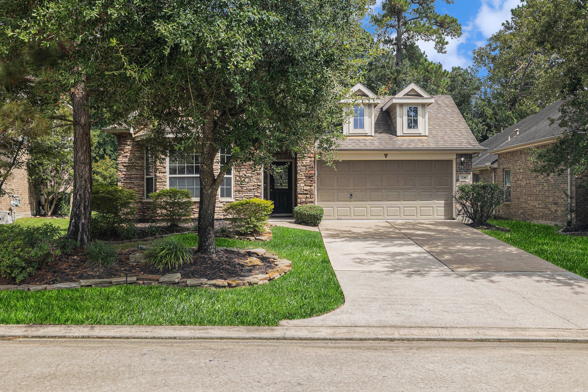 139 North Hawkhurst Circle Magnolia, TX 77354 - Photo 25 of 26 a front view of a house with garden