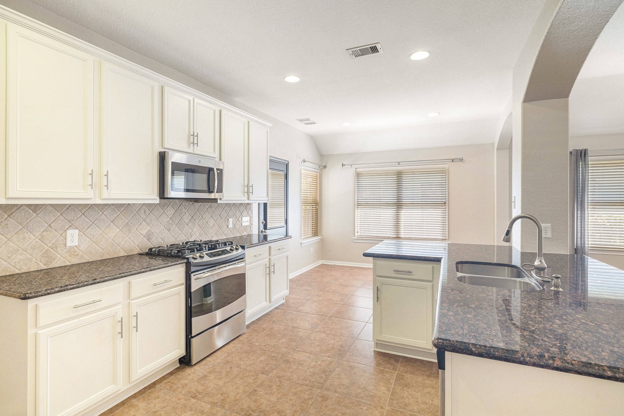 139 North Hawkhurst Circle Magnolia, TX 77354 - Photo 5 of 26 a kitchen with stainless steel appliances granite countertop a sink a stove and cabinets
