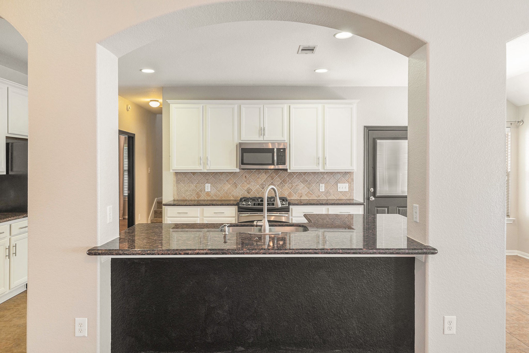 139 North Hawkhurst Circle Magnolia, TX 77354 - Photo 6 of 26 a kitchen with stainless steel appliances granite countertop a stove and a refrigerator