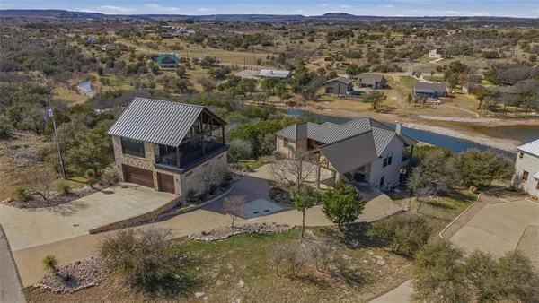 an aerial view of a house with a yard