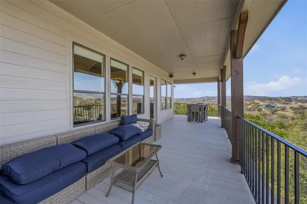 a balcony with furniture and city view