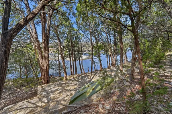 a view of a lake with houses in the back
