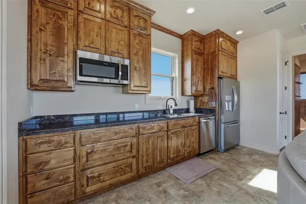 a view of a balcony with chairs and wooden floor