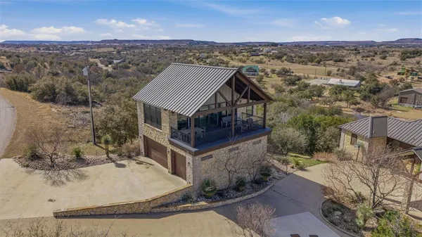 an aerial view of a house with a yard