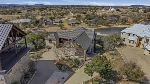 an aerial view of a house with a mountain