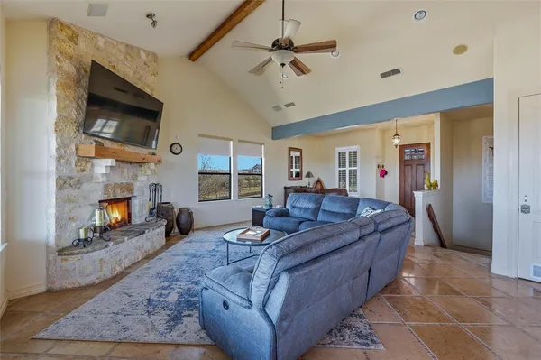 a living room with furniture a fireplace and a flat screen tv