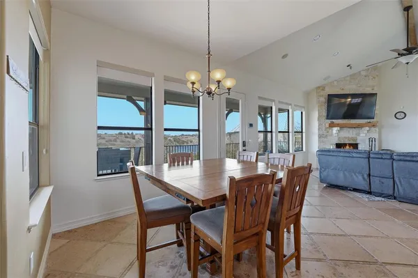 a dining room with furniture a chandelier and window