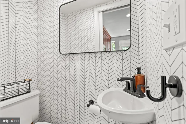 a bathroom with a sink toilet and mirror