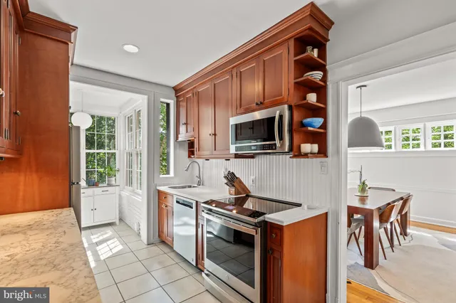 a kitchen with stainless steel appliances a stove a sink and a microwave