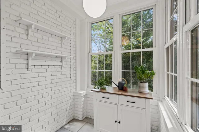 a bathroom with a window sink and mirror