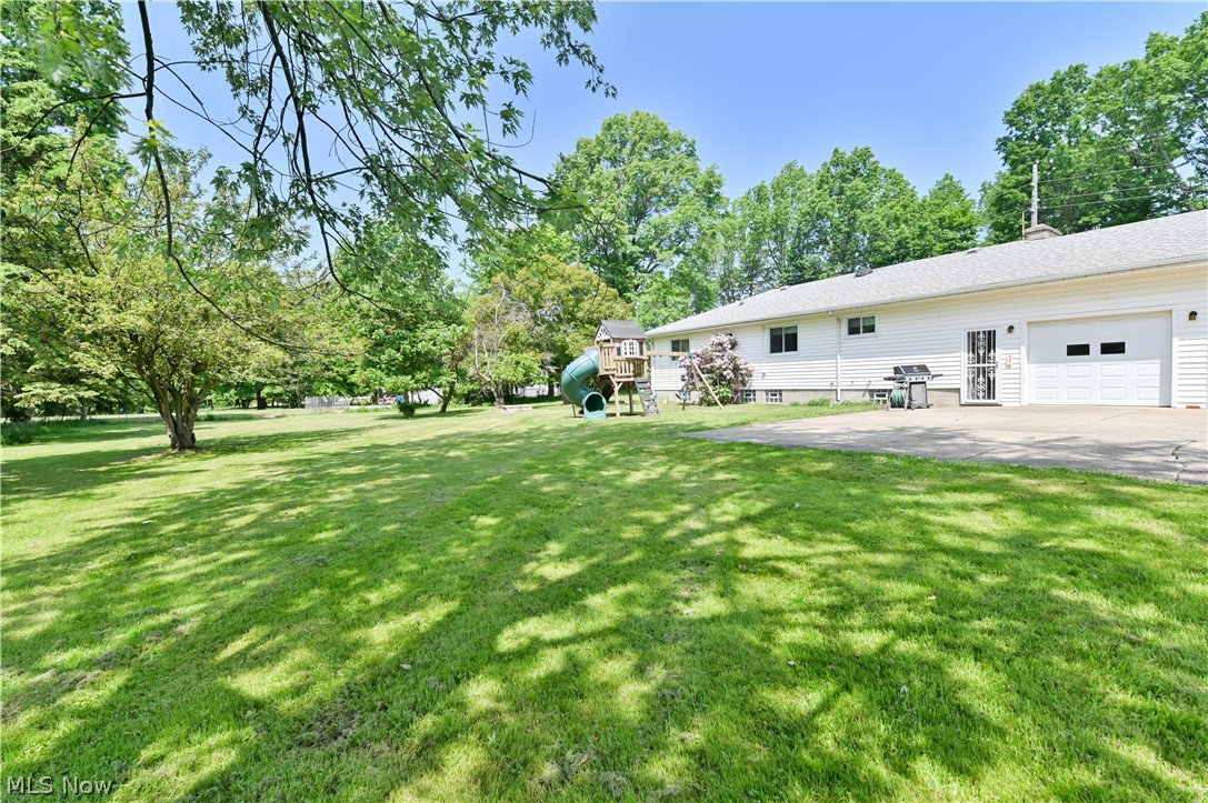 2725 Rockefeller Road Willoughby Hills, OH 44092 - Photo 17 of 21 View of yard featuring a garage