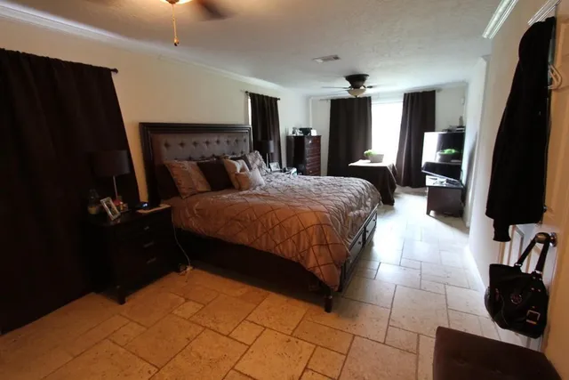 a bedroom with a bed a mirror and dresser