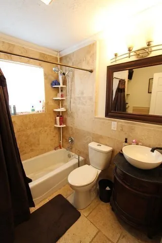 a bathroom with a double vanity sink toilet and shower