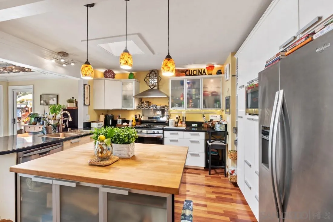 12814 Iola Way Poway, CA 92064 - Photo 13 of 36 a kitchen with stainless steel appliances granite countertop a sink a counter space and stainless steel appliances