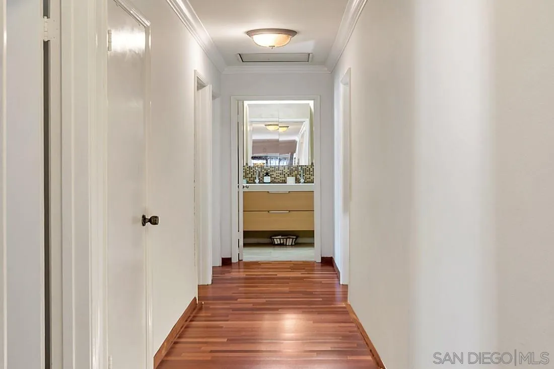 12814 Iola Way Poway, CA 92064 - Photo 15 of 36 a view of a hallway with wooden floor and a bathroom