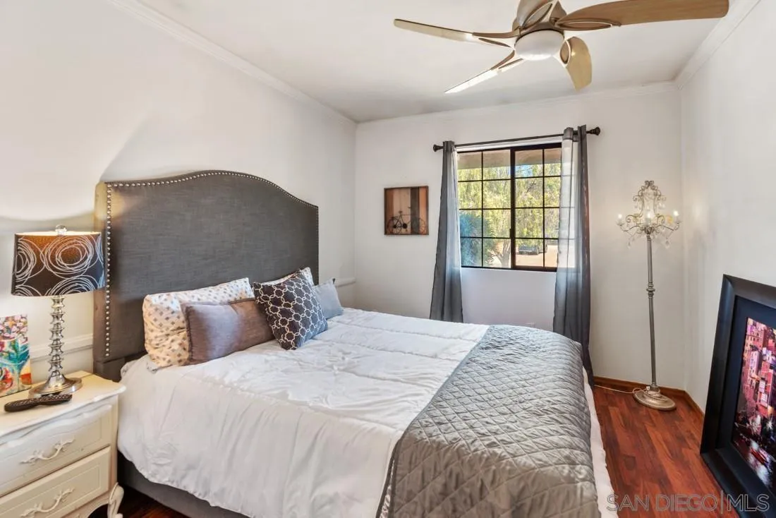12814 Iola Way Poway, CA 92064 - Photo 16 of 36 a bedroom with a bed a flat screen tv and a window