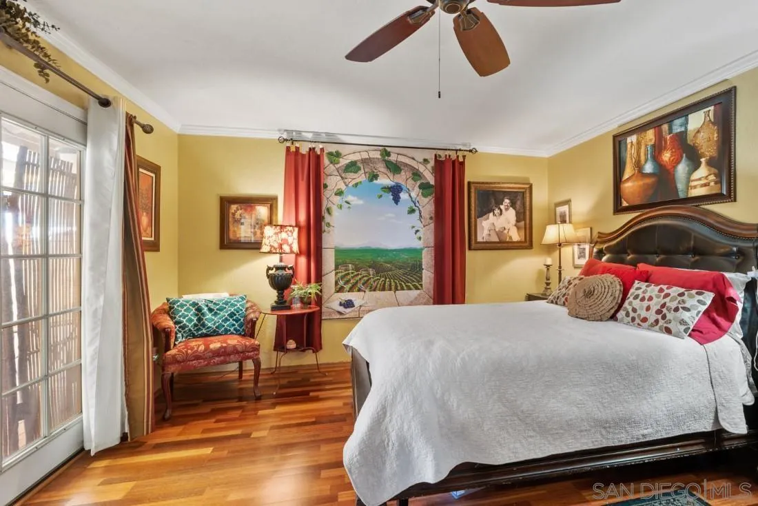 12814 Iola Way Poway, CA 92064 - Photo 20 of 36 a bedroom with a large bed and a large window with couch