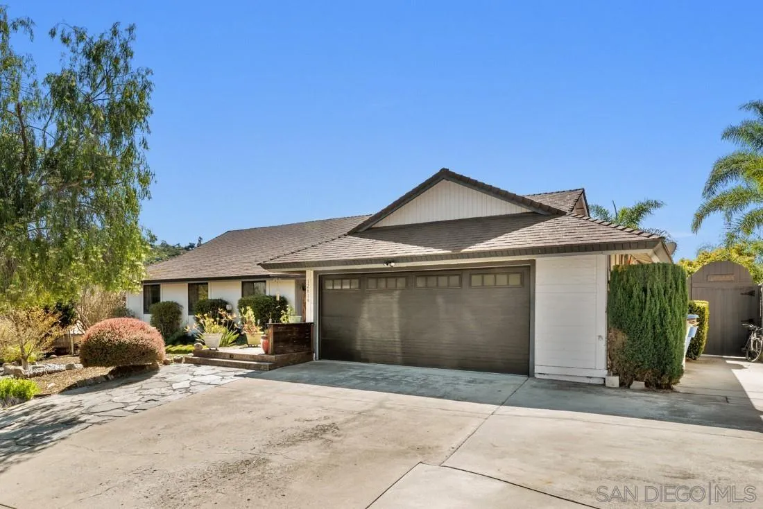 12814 Iola Way Poway, CA 92064 - Photo 2 of 36 a front view of a house with a yard and garage