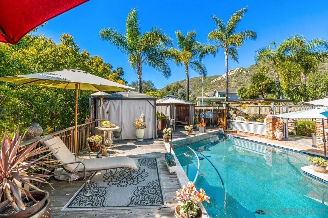 12814 Iola Way Poway, CA 92064 - Photo 25 of 36 a view of a backyard with couches chair and umbrella