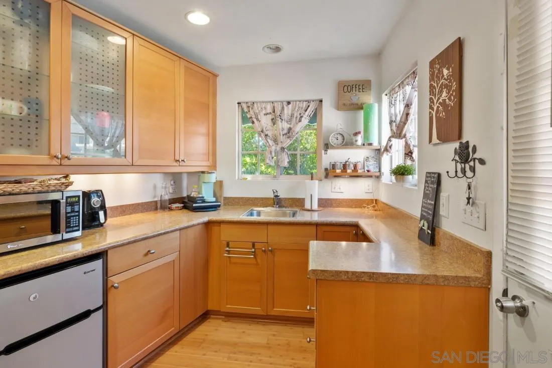 12814 Iola Way Poway, CA 92064 - Photo 35 of 36 a kitchen with a sink stove and cabinets