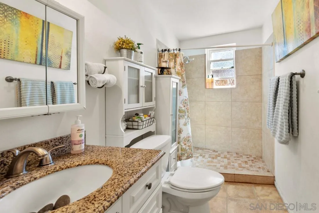 12814 Iola Way Poway, CA 92064 - Photo 36 of 36 a bathroom with a granite countertop sink toilet and shower