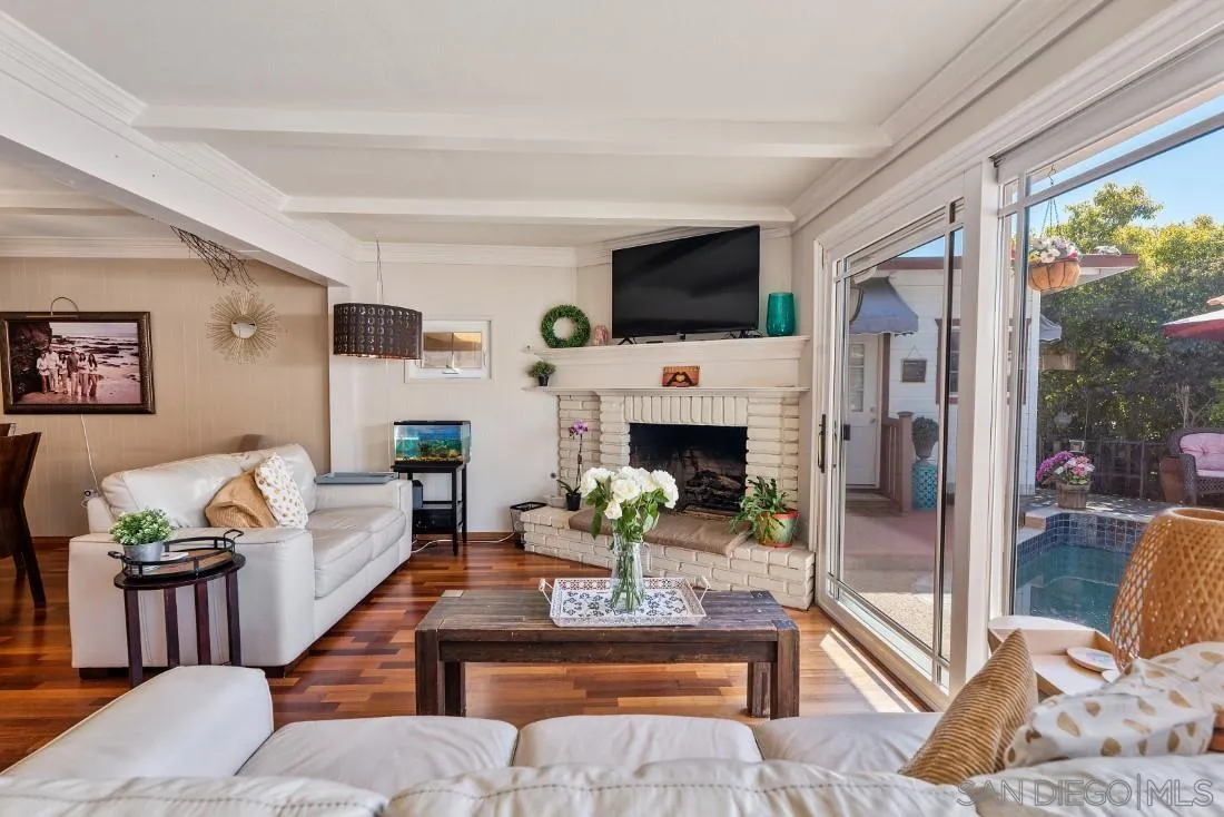 12814 Iola Way Poway, CA 92064 - Photo 9 of 36 a living room with furniture a fireplace and a flat screen tv