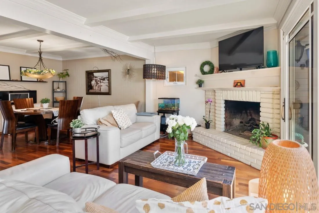 12814 Iola Way Poway, CA 92064 - Photo 10 of 36 a living room with furniture a fireplace and a flat screen tv