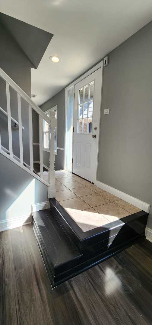 Undisclosed Address Alsip, IL 60803 - Photo 12 of 24 a room with wooden floor and windows