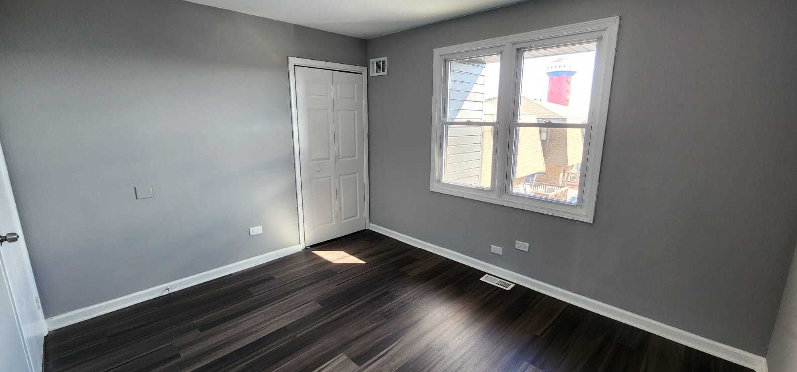 Undisclosed Address Alsip, IL 60803 - Photo 17 of 24 an empty room with wooden floor and windows
