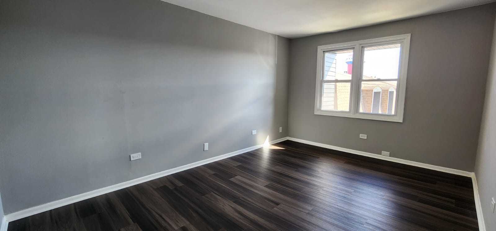 Undisclosed Address Alsip, IL 60803 - Photo 19 of 24 an empty room with wooden floor and windows