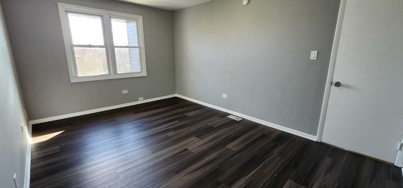 Undisclosed Address Alsip, IL 60803 - Photo 20 of 24 an empty room with wooden floor and windows