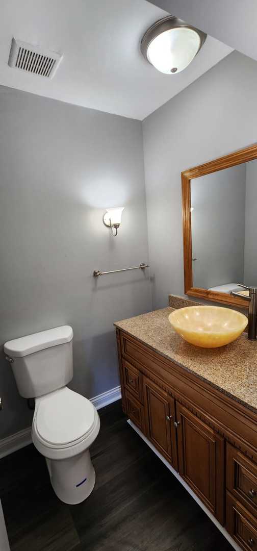 Undisclosed Address Alsip, IL 60803 - Photo 23 of 24 a bathroom with a granite countertop toilet and a sink