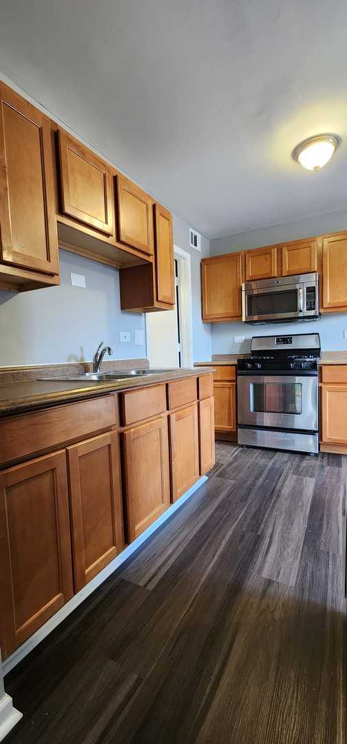 Undisclosed Address Alsip, IL 60803 - Photo 9 of 24 a kitchen with stainless steel appliances granite countertop a stove a sink and a microwave