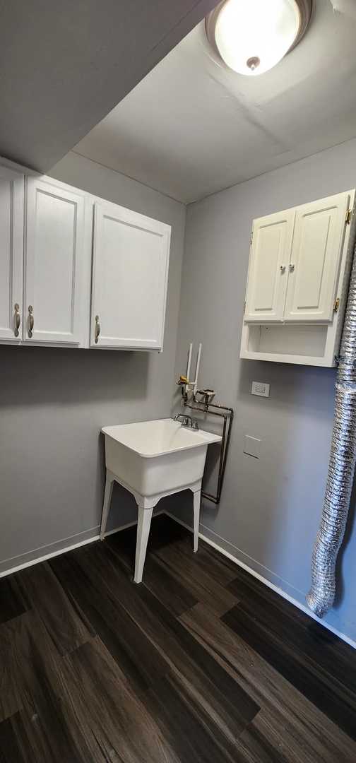 Undisclosed Address Alsip, IL 60803 - Photo 10 of 24 a kitchen with a sink cabinets and wooden floor