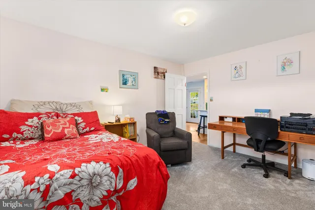 a bedroom with furniture and a flat screen tv
