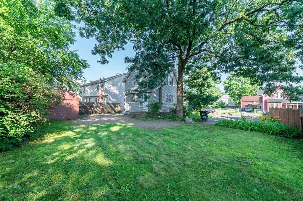 67 Keith Street Springfield, MA 01108 - Photo 27 of 27 a view of a backyard with table and chairs and a large tree