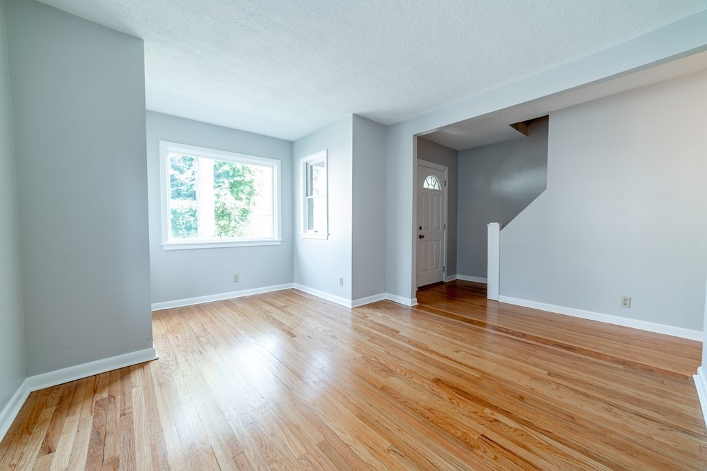 67 Keith Street Springfield, MA 01108 - Photo 8 of 27 a view of an empty room with wooden floor and a window
