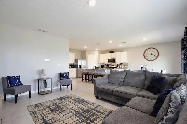 a spacious bathroom with a granite countertop sink a toilet and a mirror