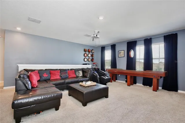 a bathroom with a tub sink and view of living room