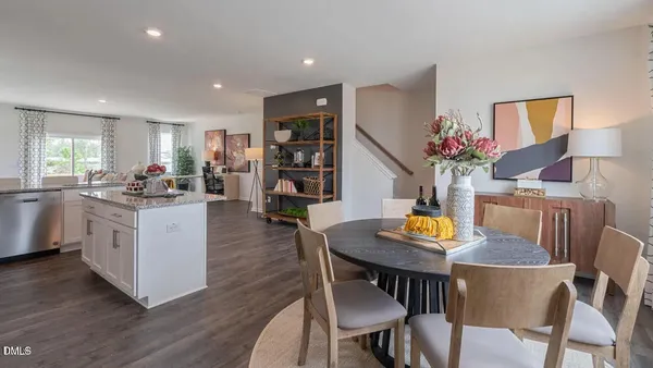 a view of kitchen with cabinets wooden floor and stainless steel appliances